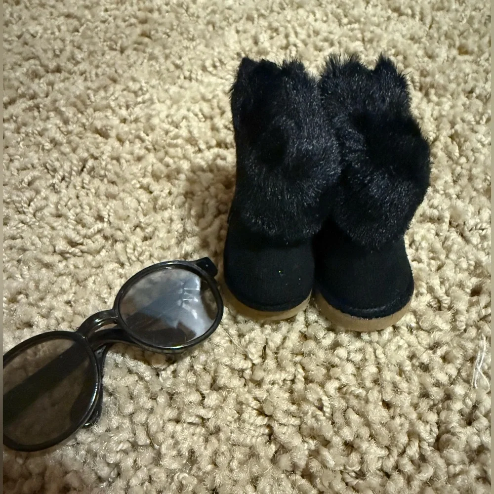 Labubu accessories: black shearling boot with zipper, and black glasses